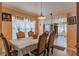 Formal dining room with wood table and chairs, and view to the back yard at 1706 Kirtley Dr, Brandon, FL 33511