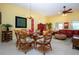 Tropical-themed dining room with glass table and wicker chairs at 2103 Grantham Greens Dr, Sun City Center, FL 33573