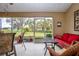 Relaxing screened porch with seating area and view of the backyard at 2103 Grantham Greens Dr, Sun City Center, FL 33573