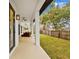 Long covered patio with access to backyard, ceiling fan at 2549 Martha Ln, Land O Lakes, FL 34639