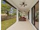 Spacious covered patio with seating area, overlooking a fenced backyard at 2549 Martha Ln, Land O Lakes, FL 34639