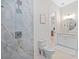 Clean bathroom with walk-in shower, toilet, and marble tile at 2549 Martha Ln, Land O Lakes, FL 34639