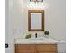 Stylish bathroom with wood vanity, quartz countertop, and framed mirror at 2549 Martha Ln, Land O Lakes, FL 34639