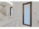 Contemporary bathroom with white vanity, quartz countertop, and frosted glass door at 2549 Martha Ln, Land O Lakes, FL 34639
