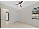 Bright bedroom with ceiling fan, large closet, and window at 2549 Martha Ln, Land O Lakes, FL 34639