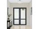 Bright entryway with double doors and a console table at 2549 Martha Ln, Land O Lakes, FL 34639