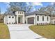Modern, single-story home with a white exterior, gray roof, and a two-car garage at 2549 Martha Ln, Land O Lakes, FL 34639