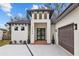 Modern home with a white exterior and a dark brown garage door at 2549 Martha Ln, Land O Lakes, FL 34639
