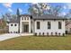 Modern white house with a gray roof and landscaped front yard at 2549 Martha Ln, Land O Lakes, FL 34639