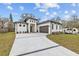 Modern house with white exterior, gray roof, and a long driveway at 2549 Martha Ln, Land O Lakes, FL 34639