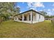 Modern house exterior with covered patio and fenced backyard at 2549 Martha Ln, Land O Lakes, FL 34639