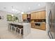 Modern kitchen with island, stainless steel appliances, and light wood cabinets at 2549 Martha Ln, Land O Lakes, FL 34639