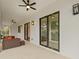 Covered patio with sliding glass doors, ceiling fans and comfortable seating at 2549 Martha Ln, Land O Lakes, FL 34639