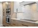 Modern kitchen with stainless steel appliances and light wood cabinets at 300 Beach Ne Dr # 1401, St Petersburg, FL 33701