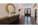 Bright entryway with dark hardwood floors and a large circular mirror at 310 8Th N Ave, St Petersburg, FL 33701