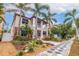 Two-story house with palm trees, landscaping, and walkway at 310 8Th N Ave, St Petersburg, FL 33701