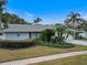 Ranch-style home with lush landscaping and a large front yard at 3104 Ashwood Ln, Safety Harbor, FL 34695