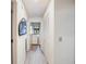 Clean hallway with tile flooring and laundry area at 3104 Ashwood Ln, Safety Harbor, FL 34695