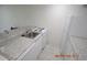 Small kitchen with white cabinets, granite countertops, and appliances at 36750 Us Highway 19 N # 23120, Palm Harbor, FL 34684