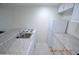 Efficient galley kitchen featuring granite countertops and white appliances at 36750 Us Highway 19 N # 23120, Palm Harbor, FL 34684