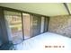 Covered patio with sliding glass doors leading to interior at 36750 Us Highway 19 N # 23120, Palm Harbor, FL 34684