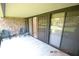 Covered patio with sliding glass doors and brick wall at 36750 Us Highway 19 N # 23120, Palm Harbor, FL 34684