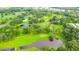 Aerial view of a lush green golf course with ponds and walking paths at 36905 Beth Ave, Zephyrhills, FL 33542