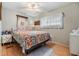 Bedroom with floral bedding and wood floors at 36905 Beth Ave, Zephyrhills, FL 33542