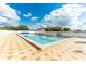 Relaxing community pool with plenty of lounge chairs under shade structures at 36905 Beth Ave, Zephyrhills, FL 33542