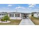 Front view of a single-wide manufactured home with landscaping at 36905 Beth Ave, Zephyrhills, FL 33542