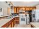 Galley kitchen with wood cabinets and stainless steel appliances at 36905 Beth Ave, Zephyrhills, FL 33542