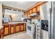 Kitchen with wood cabinets, stainless steel appliances, and breakfast bar at 36905 Beth Ave, Zephyrhills, FL 33542