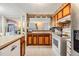 Kitchen with wood cabinets, stainless steel appliances, and breakfast bar at 36905 Beth Ave, Zephyrhills, FL 33542