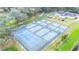Aerial view of several pickleball courts near a community building at 36905 Beth Ave, Zephyrhills, FL 33542