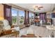 Sunroom with large windows, seating, and a dining table at 36905 Beth Ave, Zephyrhills, FL 33542