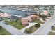 Aerial view of single-Gathering home with canal access and lush landscaping at 3734 Topsail Trl, New Port Richey, FL 34652