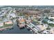 Aerial view of waterfront property with private pool, dock and canal access at 3734 Topsail Trl, New Port Richey, FL 34652