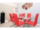 Dining room with glass table and red chairs at 3811 Carroway St, Tampa, FL 33619