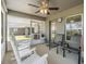 Relaxing screened porch with rocking chairs and ceiling fan at 38189 Countryside Pl, Dade City, FL 33525