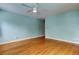 Light teal bedroom with hardwood floors and ceiling fan at 4059 Benson N Ave, St Petersburg, FL 33713