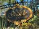 Elegant community sign for Golfside at Lansbrook with decorative wrought iron fence and lush foliage at 4161 Grandchamp Cir, Palm Harbor, FL 34685