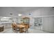 Bright dining area with wood table and chairs near kitchen and patio at 419 Wayfarer Ct, Tarpon Springs, FL 34689