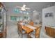 Spacious dining room with wood table and chairs, overlooking backyard at 419 Wayfarer Ct, Tarpon Springs, FL 34689