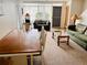 Living area with dining table, sofas, and a coffee table at 4352 Tahitian Gardens Cir # E, Holiday, FL 34691