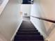 Carpeted staircase with wooden handrail at 4352 Tahitian Gardens Cir # E, Holiday, FL 34691
