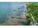 Aerial view of waterfront property with private docks and lush landscaping at 458 Grant St, Dunedin, FL 34698