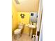 Small bathroom with yellow walls and pedestal sink at 458 Grant St, Dunedin, FL 34698