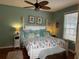 Bright bedroom with hardwood floors and a ceiling fan at 458 Grant St, Dunedin, FL 34698