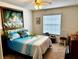Guest bedroom with a large tropical-themed painting at 458 Grant St, Dunedin, FL 34698