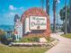 Welcome to Dunedin sign with brick arch and bagpiper statue at 458 Grant St, Dunedin, FL 34698